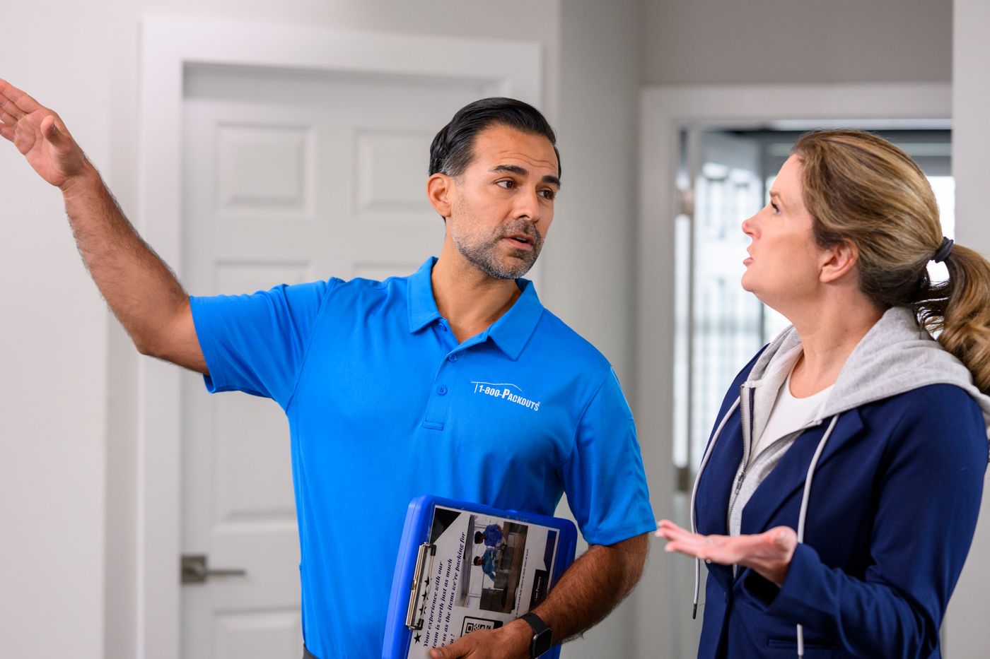 1-800-Packouts technician consulting with homeowner after fire damage